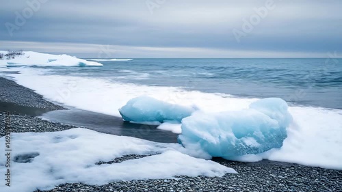 Sapphire Ice on Iceland's Black Sand Beach Under Cloudy Sky
