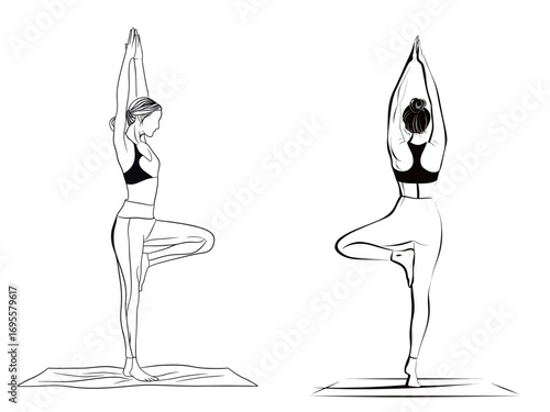 Two women are focusing on their balance as they perform tree pose on their yoga mats. The session takes place in a serene setting, enhancing their mindfulness.