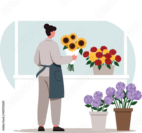 Florist arranging a bouquet of sunflowers and roses.