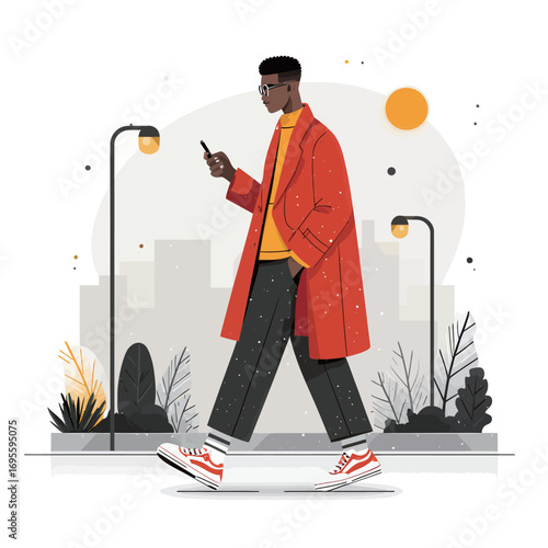 A fashionably dressed young man strolls through a city street wearing a red coat and stylish sneakers. He is focused on his smartphone, indicating modern urban life.