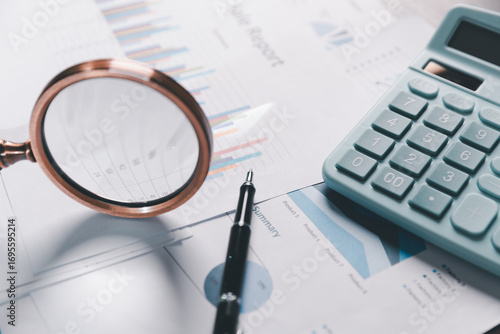 Papier peint Auditor reviews financial statement and balance sheet on desk using a calculator, representing the concept of accounting, audit, and finance in preparing a detailed financial report for the business