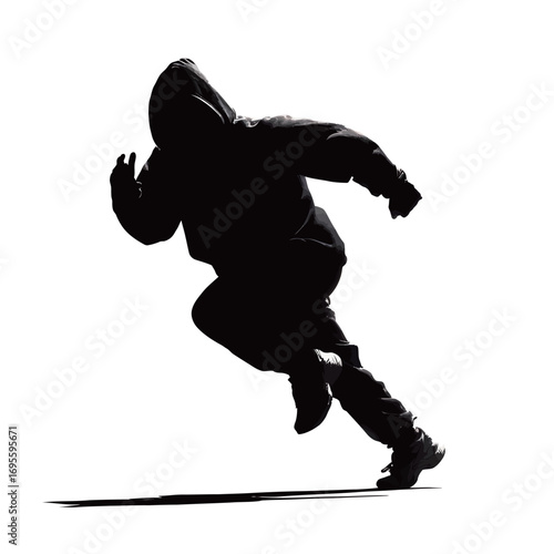 A person in dark athletic clothing is captured in motion, sprinting with determination.