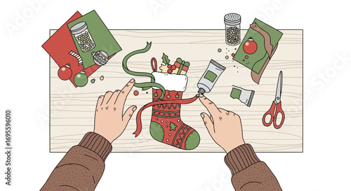 Festive christmas stocking craft project on wooden table viewed from overhead angle
