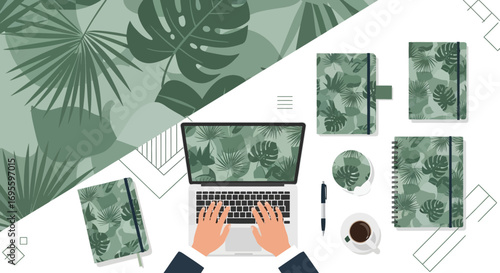 Workspace with tropical foliage pattern laptop, notebooks and a coffee cup creating a trendy
