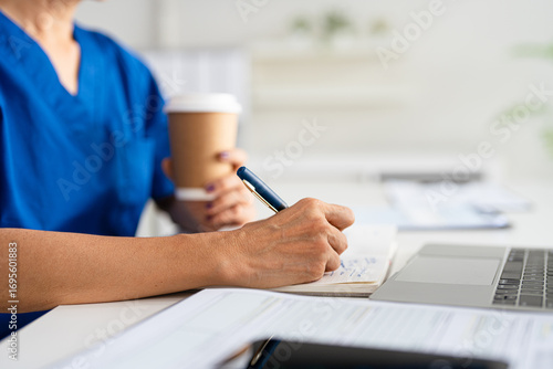 closeup Hand Writing, book and notebook by doctor or healthcare professional with a prescription or making notes in an office.