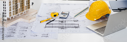 Architect or engineer professional. blueprint , structual  floor plans   with  a pencil,  triangular scale , Shop drawing ,  calculator,  laptop and engineering tools.