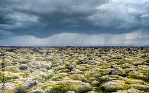 Rain storm over moss covered lava field, Iceland
