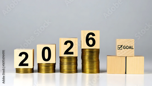 Wooden Blocks 2026 on Golden Coins with Goal, Plan, and Action Pyramid, Ideal for financial planning, New Year’s resolutions, or business development visuals.