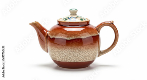 A round, glazed ceramic teapot with a lid, featuring a decorative floral pattern.