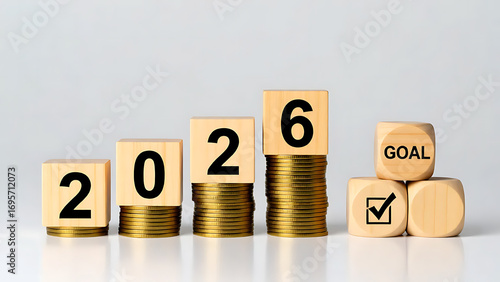Wooden Blocks 2026 on Golden Coins with Goal, Plan, and Action Pyramid, Ideal for financial planning, New Year’s resolutions, or business development visuals.