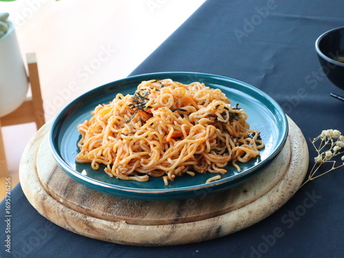 Stir-fried instant noodles with vegetables and meat, a quick and flavorful Thai comfort food dish loved for its savory taste.