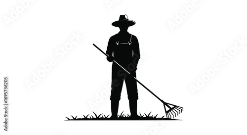 a farmer silhouette holding rake standing on grass