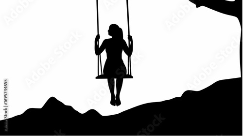 Silhouette of a woman on a swing hanging from a tree branch with a mountain landscape in the background