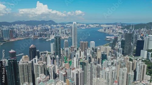 Wallpaper Mural Aerial drone footage capturing Hong Kong harbour with city skyline, bustling vessels, and waterfront views, highlighting maritime transport, urban architecture, and iconic coastal landscapes Torontodigital.ca
