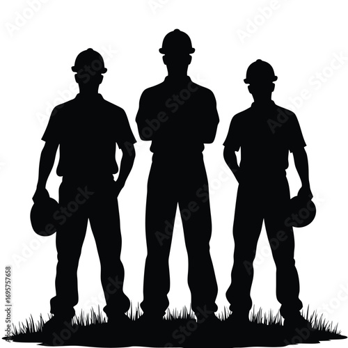 Silhouette of three construction workers standing in grass
