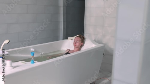A girl takes a therapeutic thermal bath.