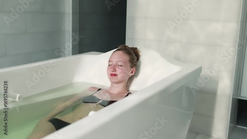 A girl takes a therapeutic thermal bath.