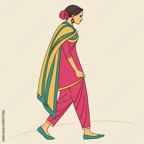 Woman in a salwar kameez walking, showcasing traditional indian fashion style