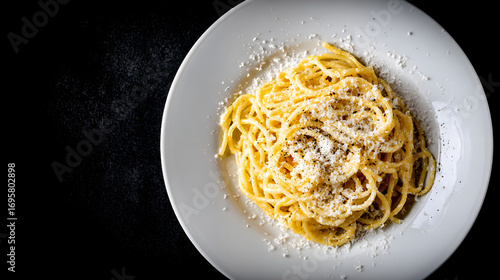 Spaghetti Cacio e Pepe on White Plate with Parmesan