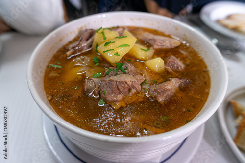 Traditional Portuguese lamb stew, a slow-cooked dish with tender meat, potatoes, and rich spices, popular in rustic cuisine and authentic Mediterranean gastronomy.