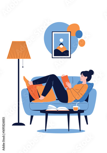 Relaxing person reading book on sofa with lamp and artwork on wall enjoying leisure time at home