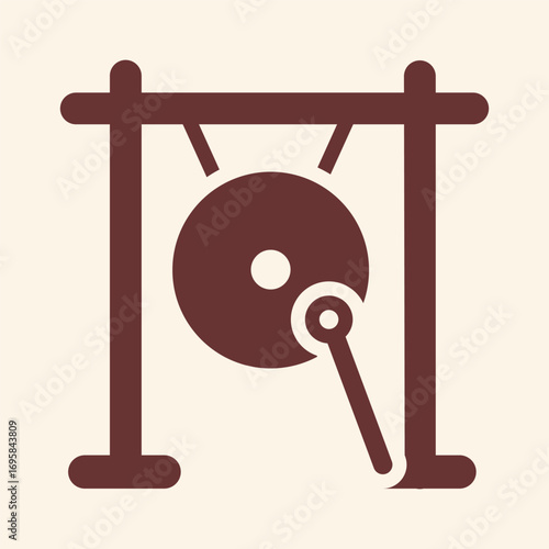 Striking gong with mallet signaling announcement or ceremony, traditional sound instrument for events