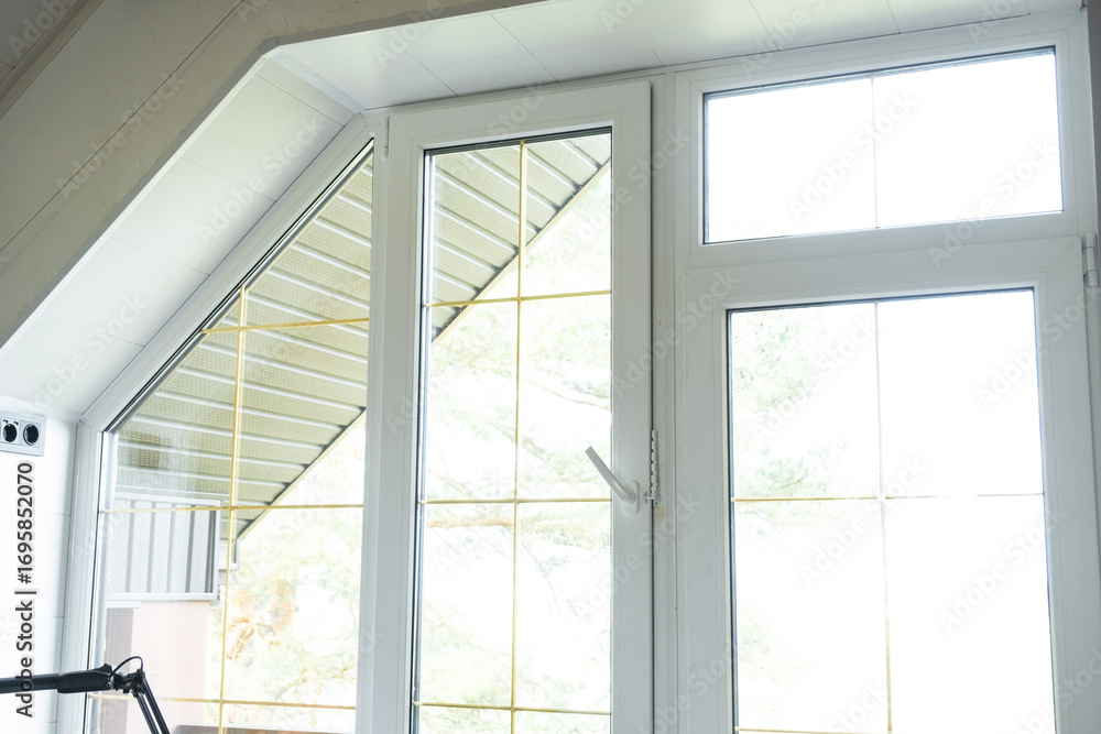 Fototapeta premium Window attic from inside the house plastic double-glazed window, clean glass after cleaning windows, open and closed window, window fittings