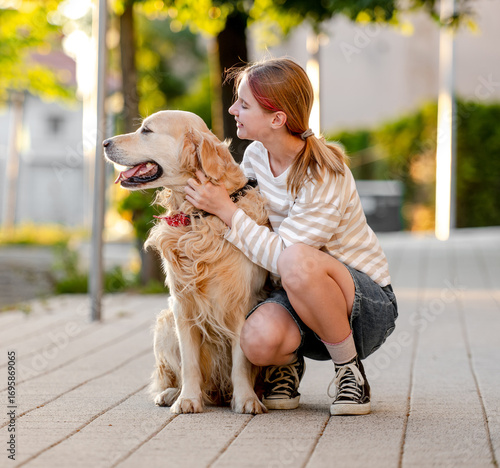 Canvas Print Happy Girl Hugging Golden Retriever Dog Outside