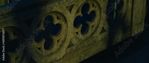 Gothic quatrefoil railing detail on Milan Cathedral rooftop at dusk lighting