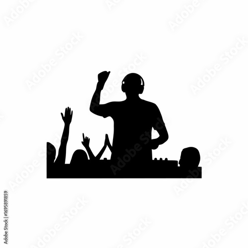 Silhouette of a dj performing for a cheering crowd with hands raised