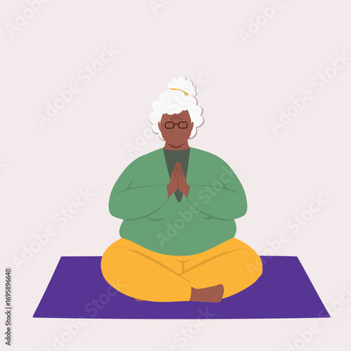 Overweight Black Elderly Woman Sitting On Mat With Legs Crossed While Practicing Yoga In A Prayer Pose.