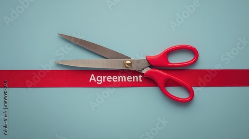 Scissors on red ribbon labeled agreement, symbolizing contract termination, cancellation, rescission, business conflict, failed negotiation, and broken deal.
