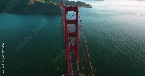 Aerial view of the Golden Gate Bridge with its striking red hue contrasting against the deep blue ocean, creating a stunning visual, San Francisco, California, United States.