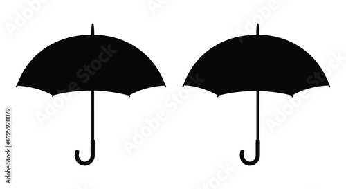 two black umbrellas side by side on white background