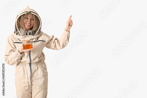Female beekeeper with jar o...