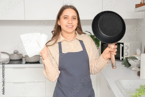 Housewife with frying pan a...