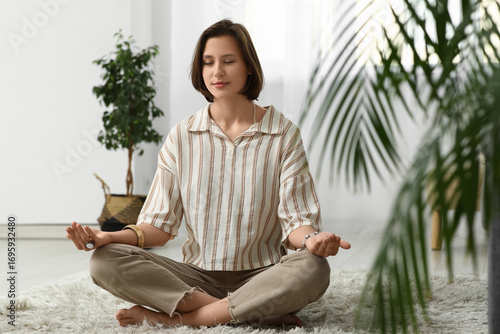 Young woman meditating whil...