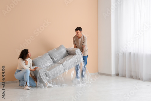 Young couple moving packed ...