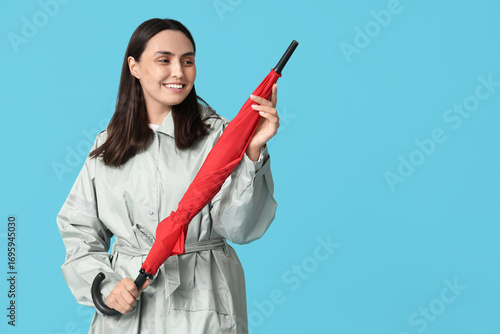 Happy young woman with umbr...