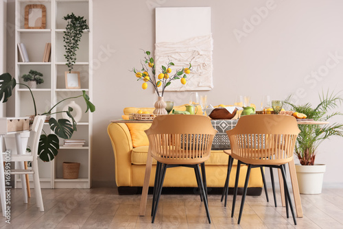 Interior of dining room with table setting and beautiful lemon tree branches
