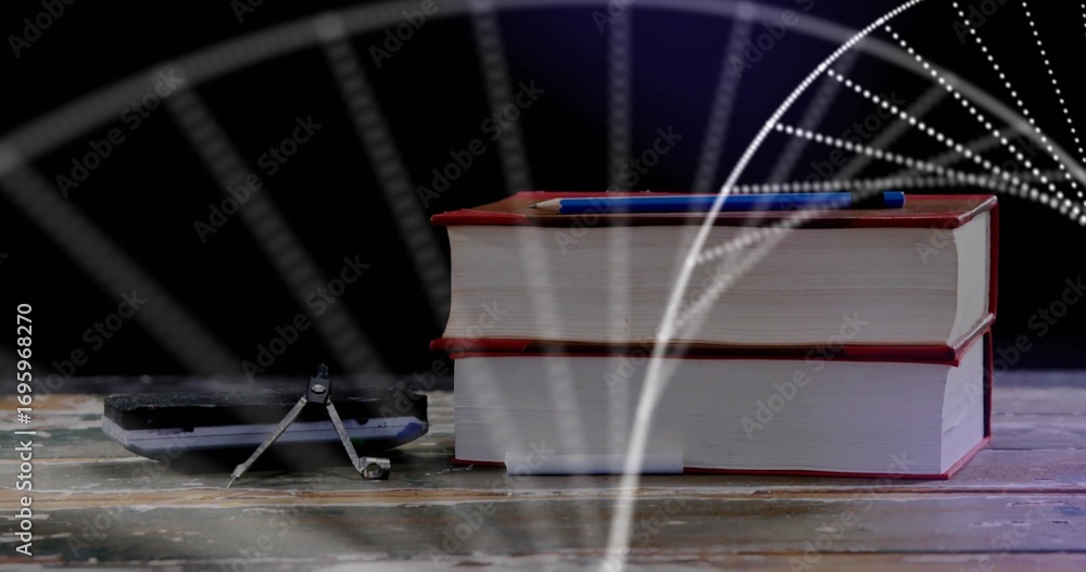 Naklejka premium Displaying two red-bound books stacked on studio tabletop with blue pen, compass and calculator