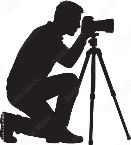 Silhouette of a photographer kneeling and taking a picture with a tripod