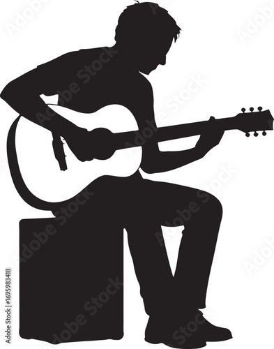 Silhouette of a person playing an acoustic guitar while sitting