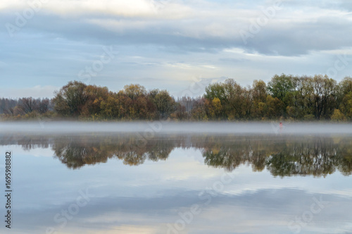 Autumn river foggy landscape, autumn mist at the river, foggy landscape with water reflections