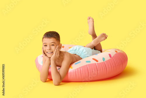 Cute little boy lying on in...