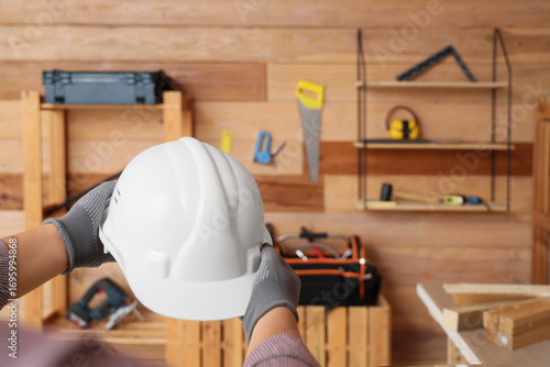 Male hands holding hardhat ...