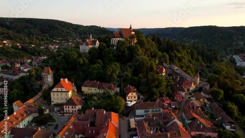 School hill of Sighisoara Romanian old city at sunset. Aerial view