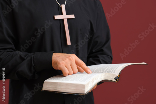 Young priest with wooden cr...