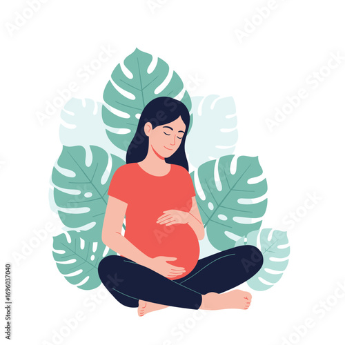 Peaceful pregnant woman sitting in a meditation pose surrounded by lush green tropical leaves embracing her growing baby bump with loving care and gentle mindfulness