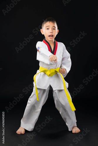 Young Asian man in white clothes standing with one punch punching taekwondo sport